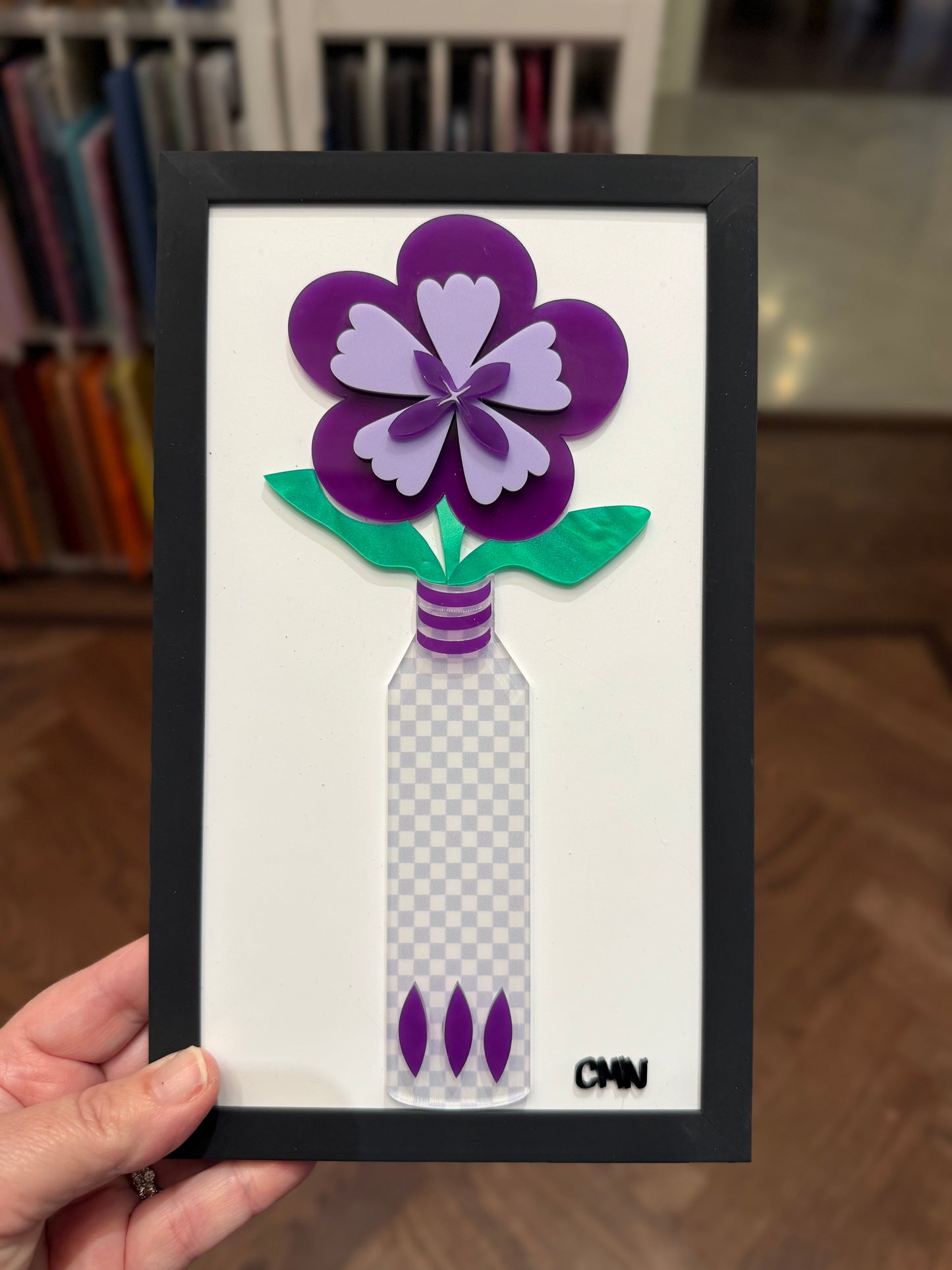 Purple flower with gray checkerboard vase