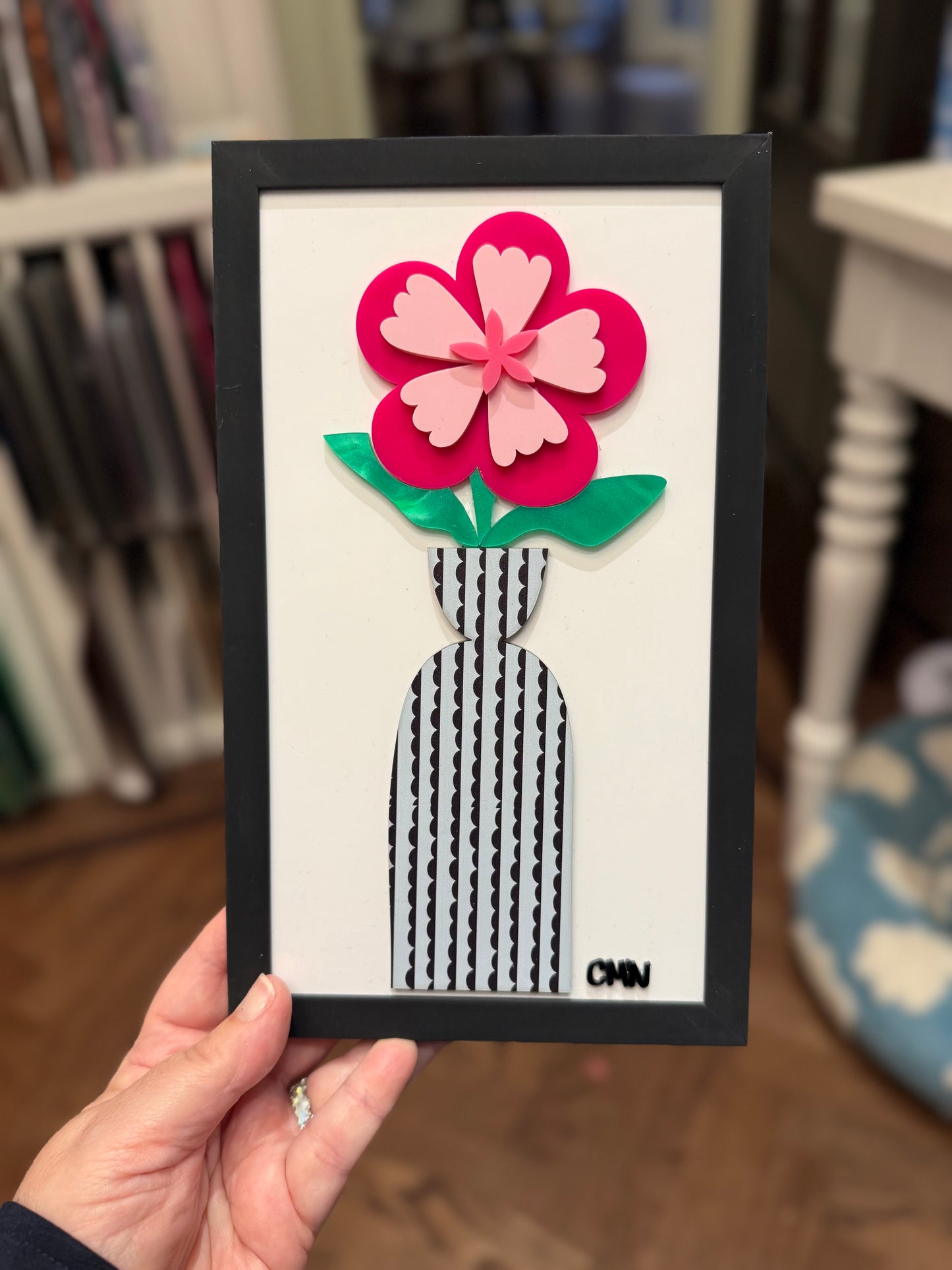 Pink flower with scalloped striped vase