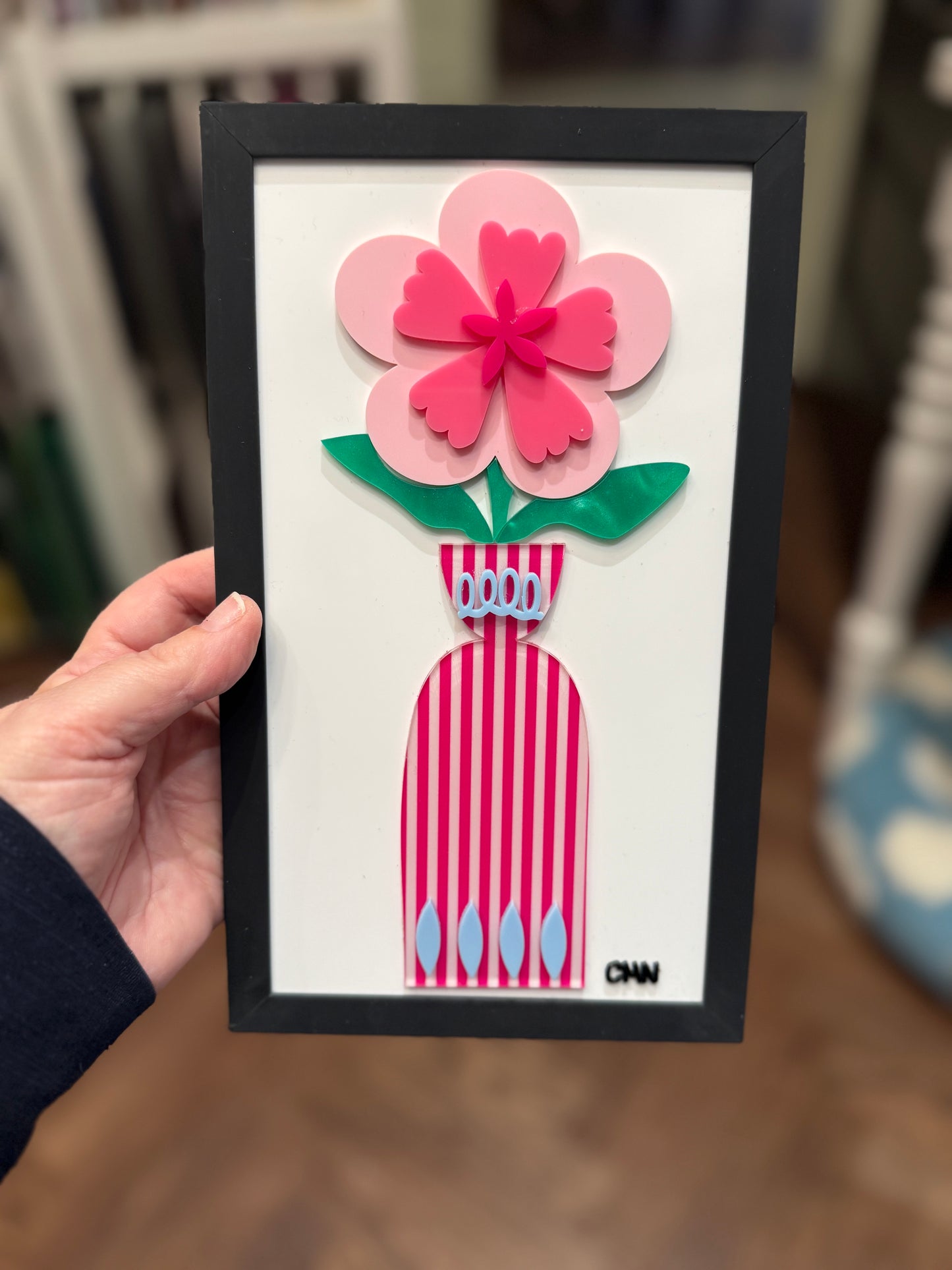 Pink flower with pink striped vase